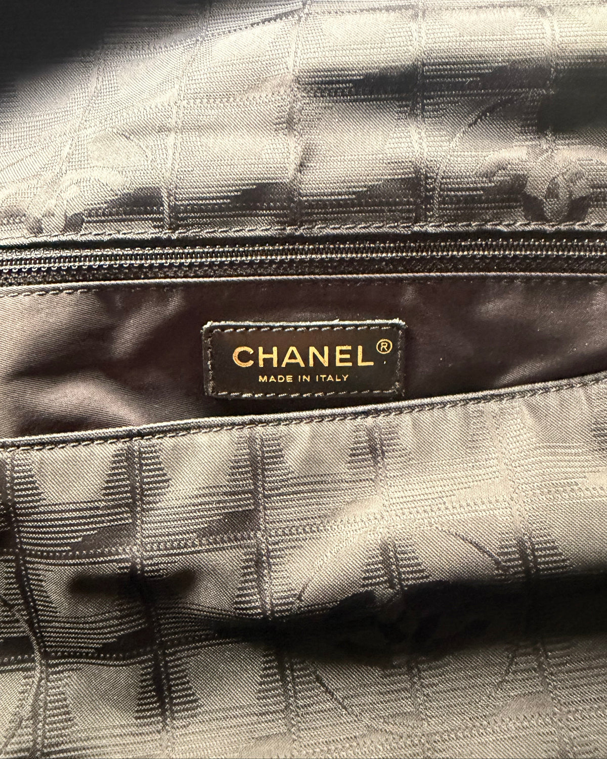 CHANEL® label on checked fabric interior of nylon messenger bag