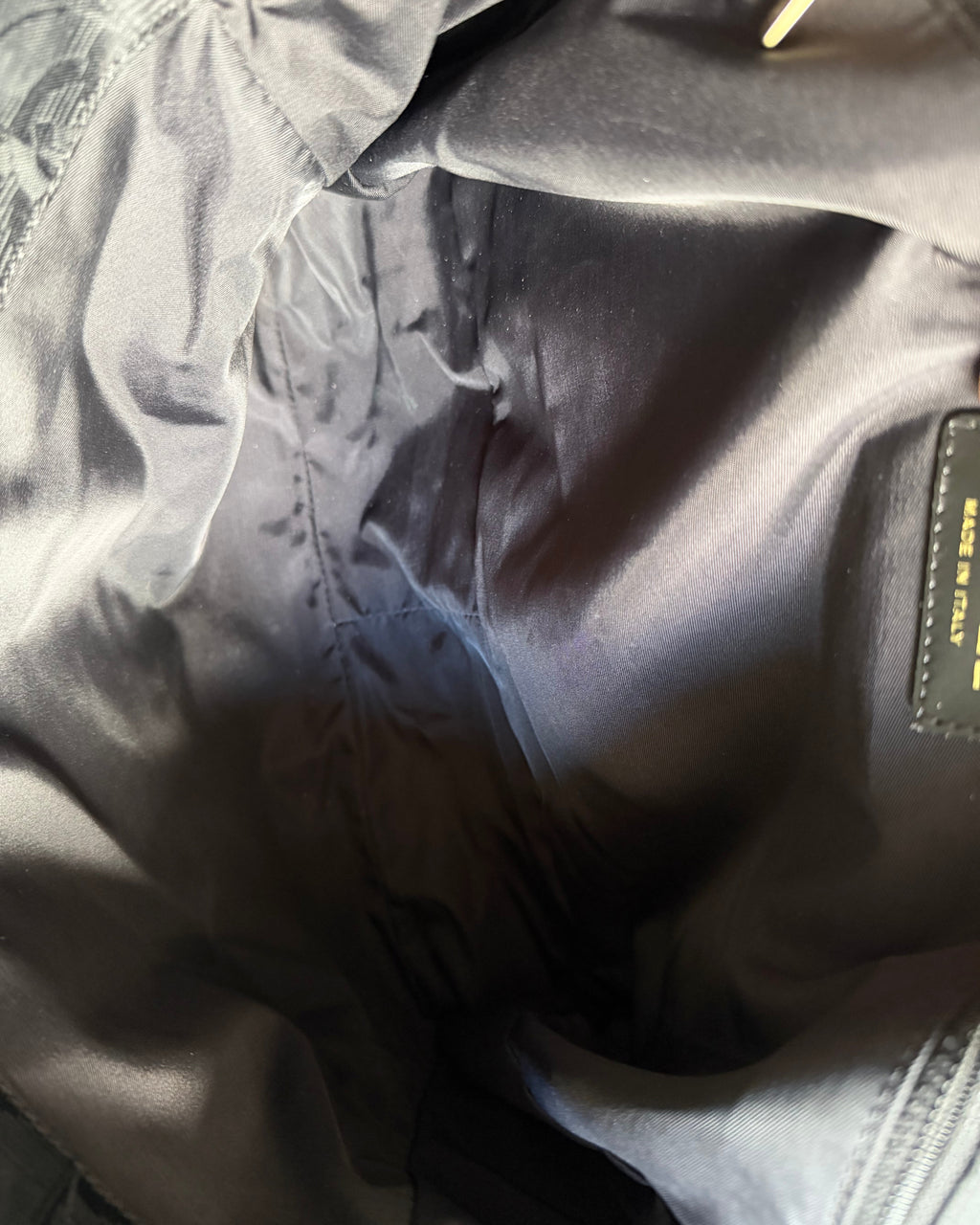 Nylon messenger bag interior pocket with CHANEL® label tag