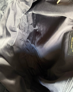 Nylon messenger bag interior pocket with CHANEL® label tag