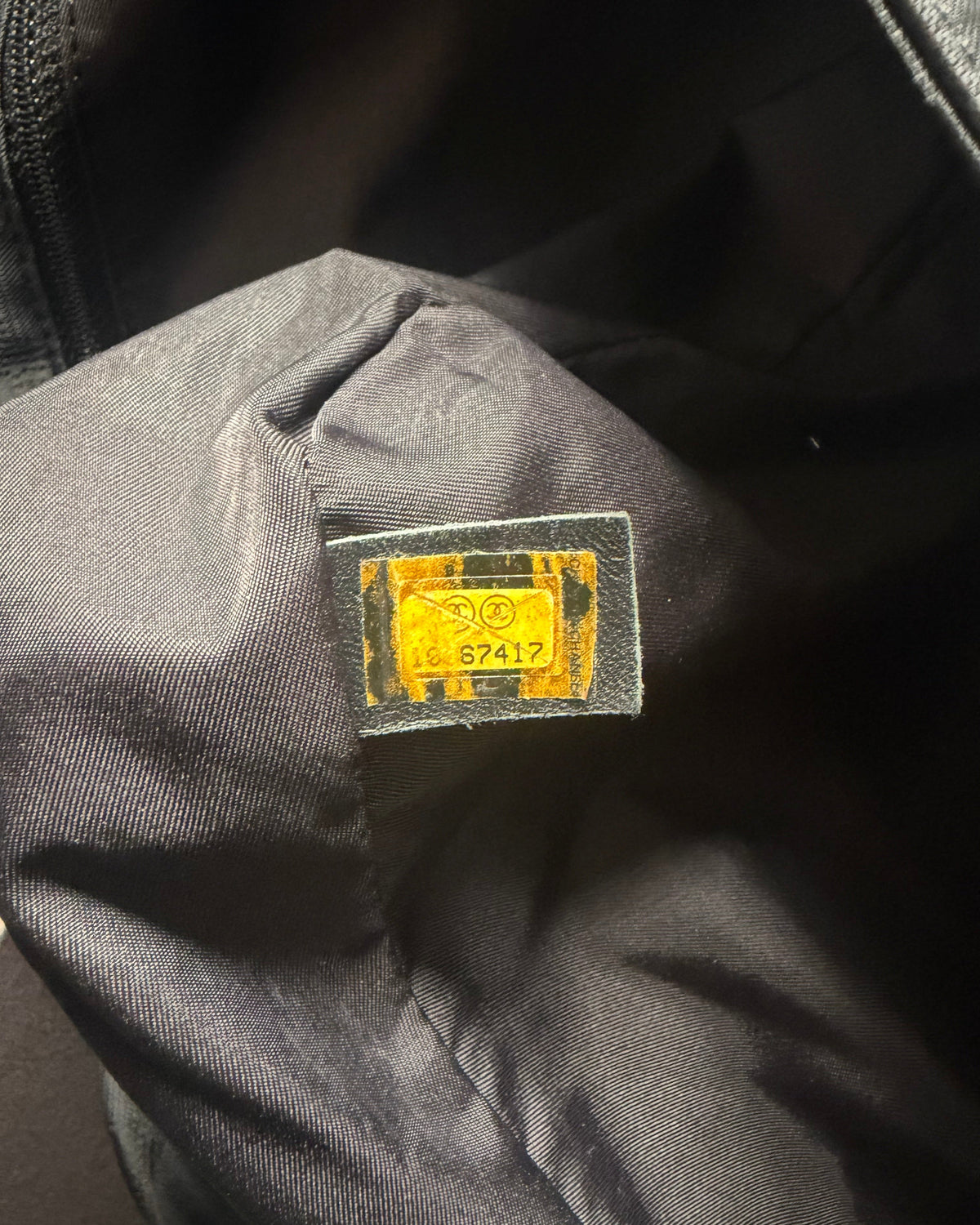 Grey nylon messenger bag interior with small fabric label