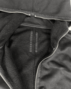 Dark hybrid hoodie close-up of front zip and fleece-lined interior panel
