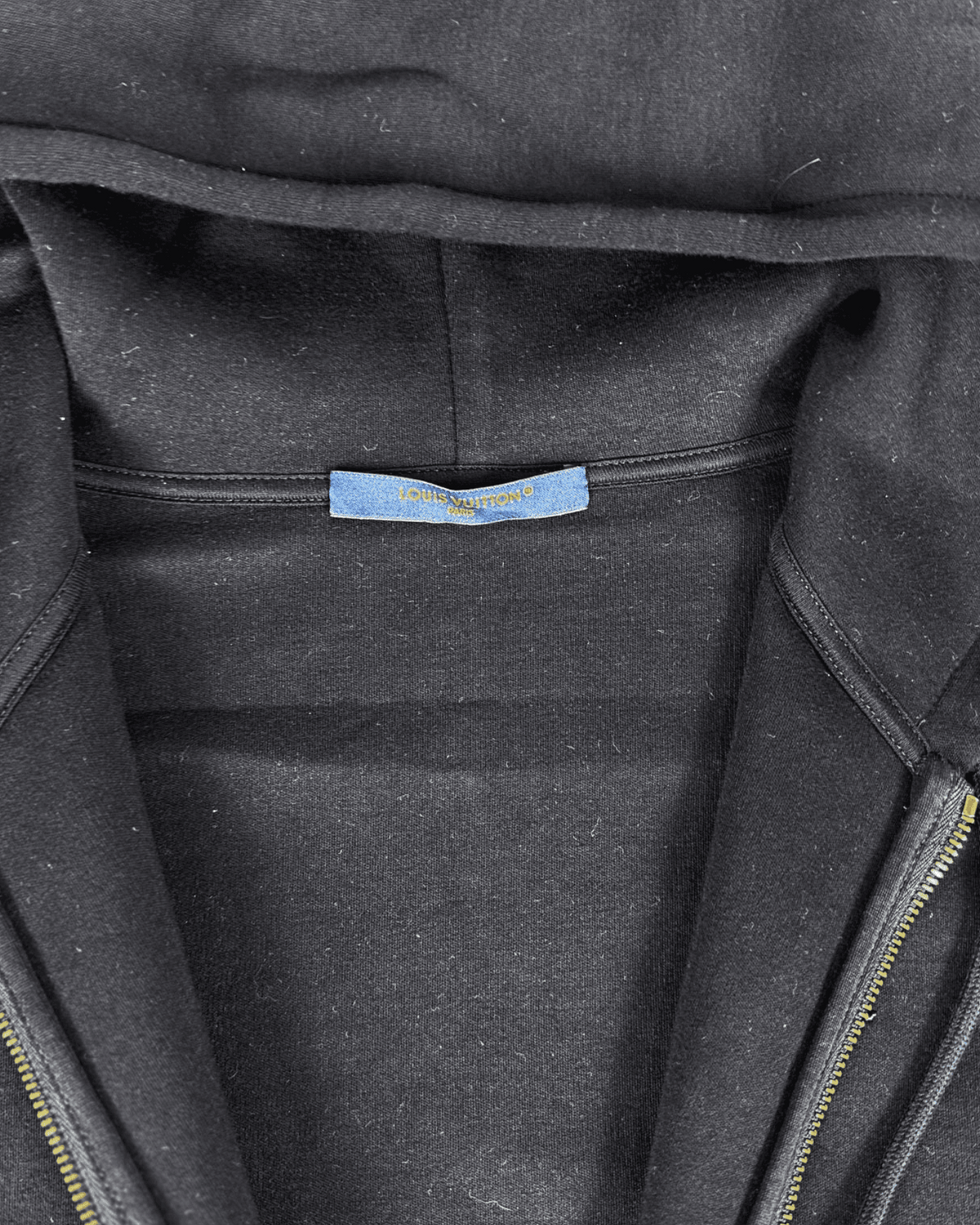 Blue Louis Vuitton logo label inside zip-up hoodie