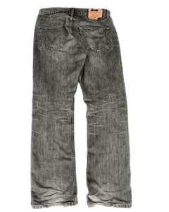 Distressed grey denim jeans with whisker wash and leather back patch