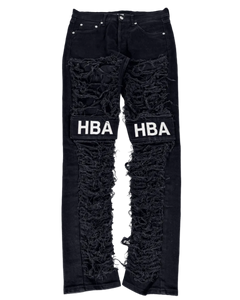 Black distressed denim jeans with large knee rips and HBA logo print on patches