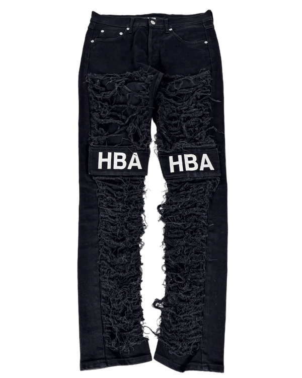Black distressed denim jeans with large knee rips and HBA logo print on patches
