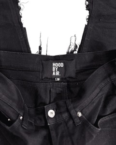 Distressed black denim jeans with HOOD BY AIR waistband tag and knee patch detailing