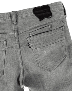 Grey denim jeans back pocket with heart-shaped cutout patch and belt loop