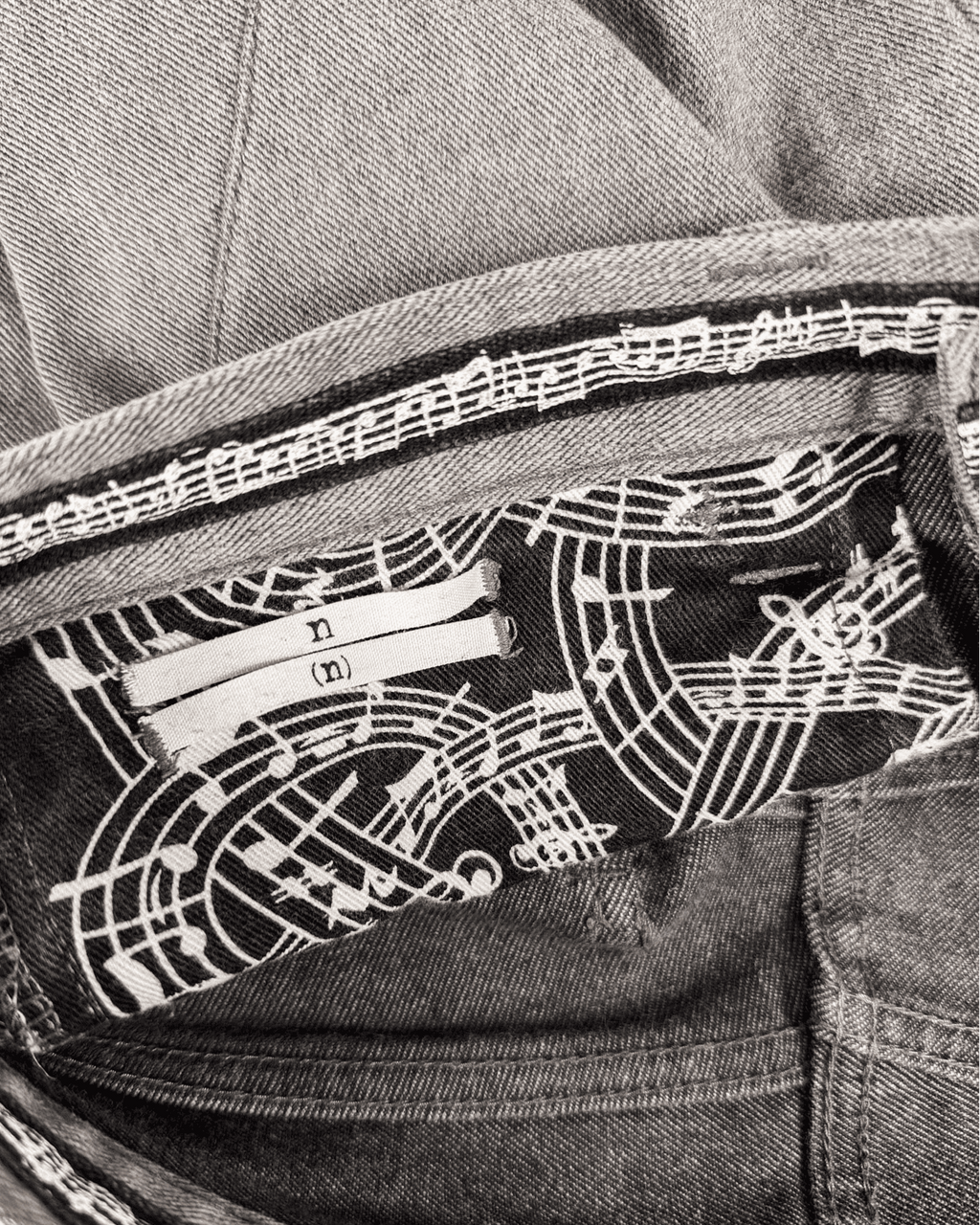 Inside waistband lining with dark-and-white music-note pattern and brand tag