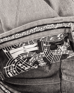Inside waistband lining with dark-and-white music-note pattern and brand tag
