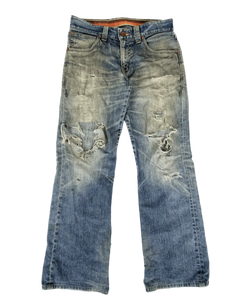 Distressed light-blue denim jeans with torn knees and large back-pocket rips