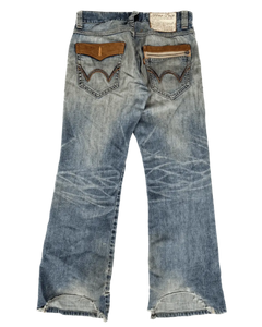 Distressed light-blue denim jeans with brown patch pockets and frayed hem