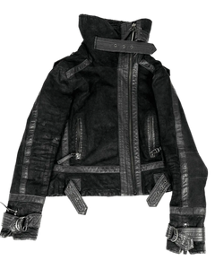 Dark high-collar buckle jacket front with zip placket, patch pockets, and metal strap details