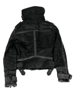 Dark high-collar buckle jacket back with central panel, seams, and cuff strap closures