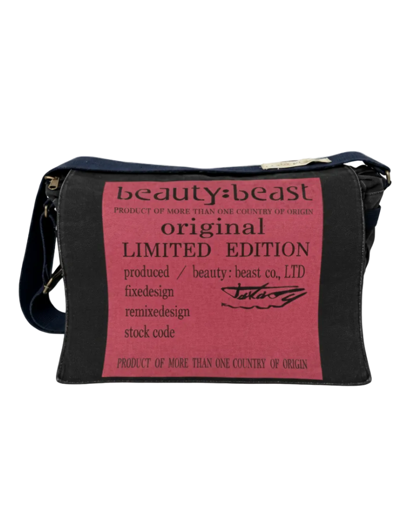 Dark messenger bag with front printed pink panel and gold-tone zipper pull