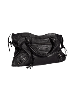 Black leather satchel with top handle, front zipper pocket, and side stud details