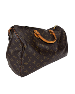 Louis Vuitton monogram duffle bag with tan strap and top handles, side view