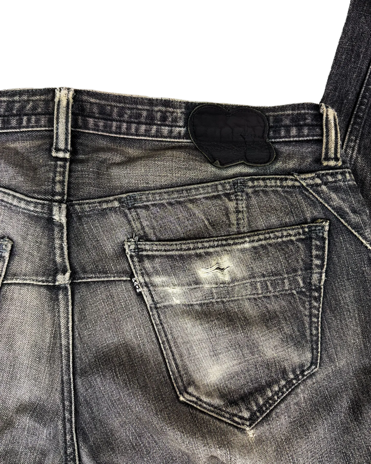 Washed denim jeans back pocket with leather-look patch and contrast stitching