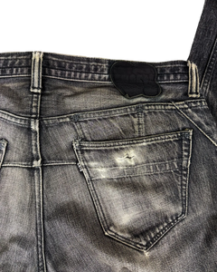Washed denim jeans back pocket with leather-look patch and contrast stitching