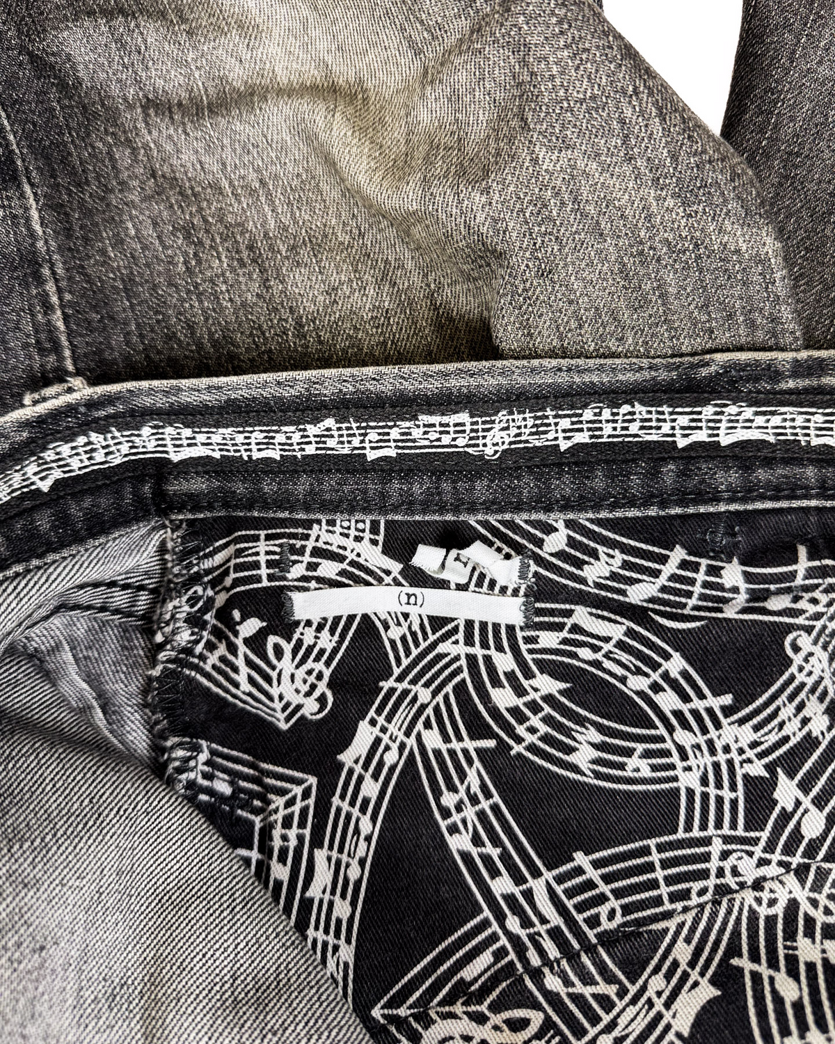 Denim jeans interior with white graphic lining and black patterned panel