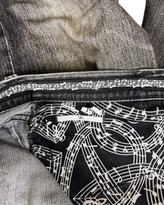 Denim jeans interior with white graphic lining and black patterned panel