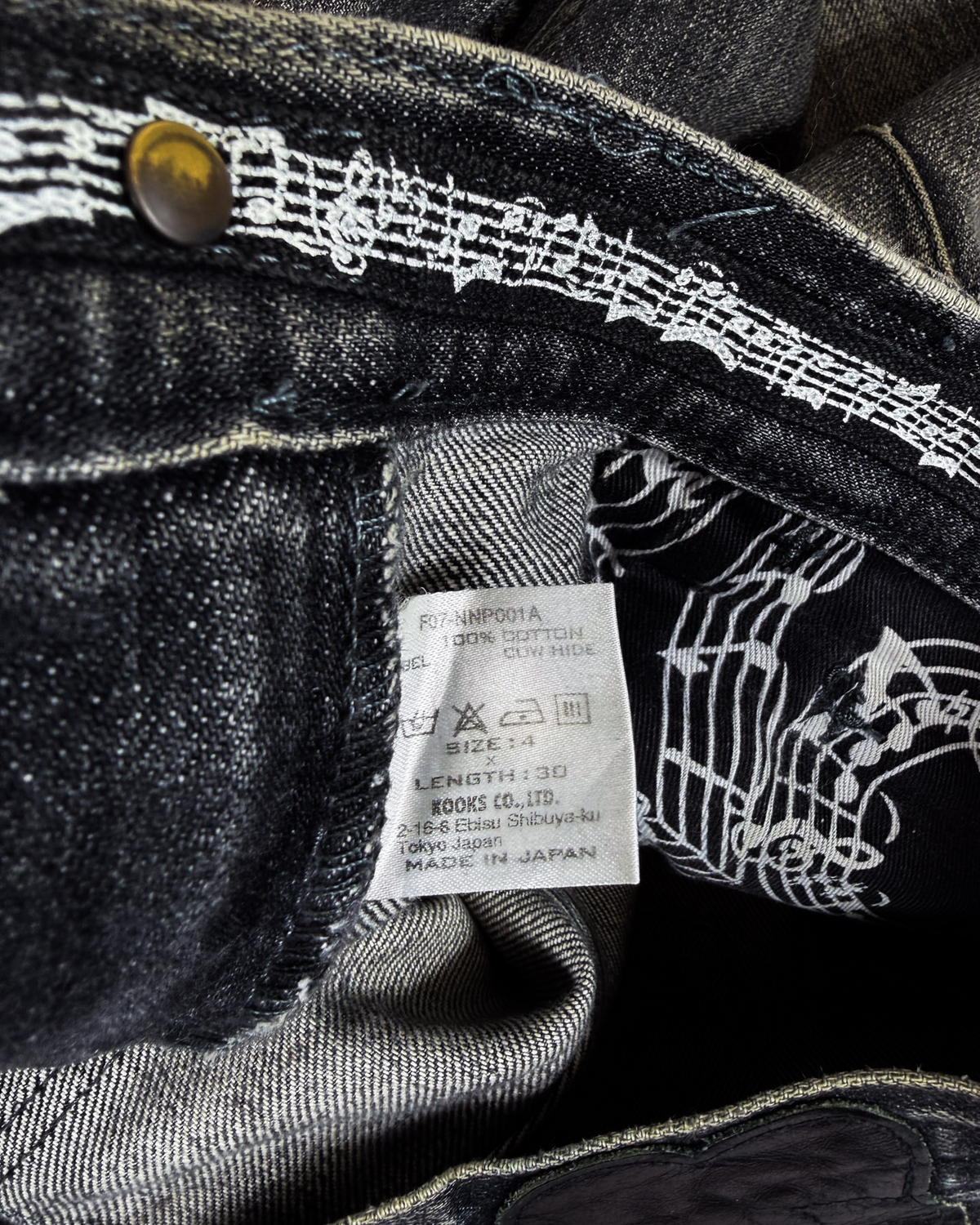 Denim jeans label and striped inner waistband, dark graphic lining