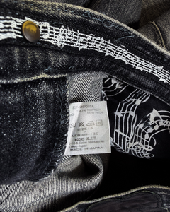 Denim jeans label and striped inner waistband, dark graphic lining