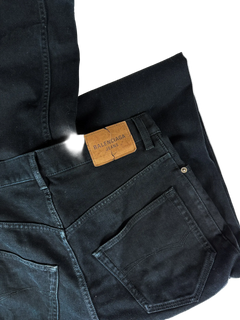 Black denim jeans with stitched front pockets and leather Balenciaga patch.