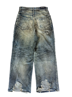Washed blue denim jeans with distressed rips and stitched hems