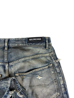 Blue denim jeans close-up with BALENCIAGA waistband label and stitched pocket