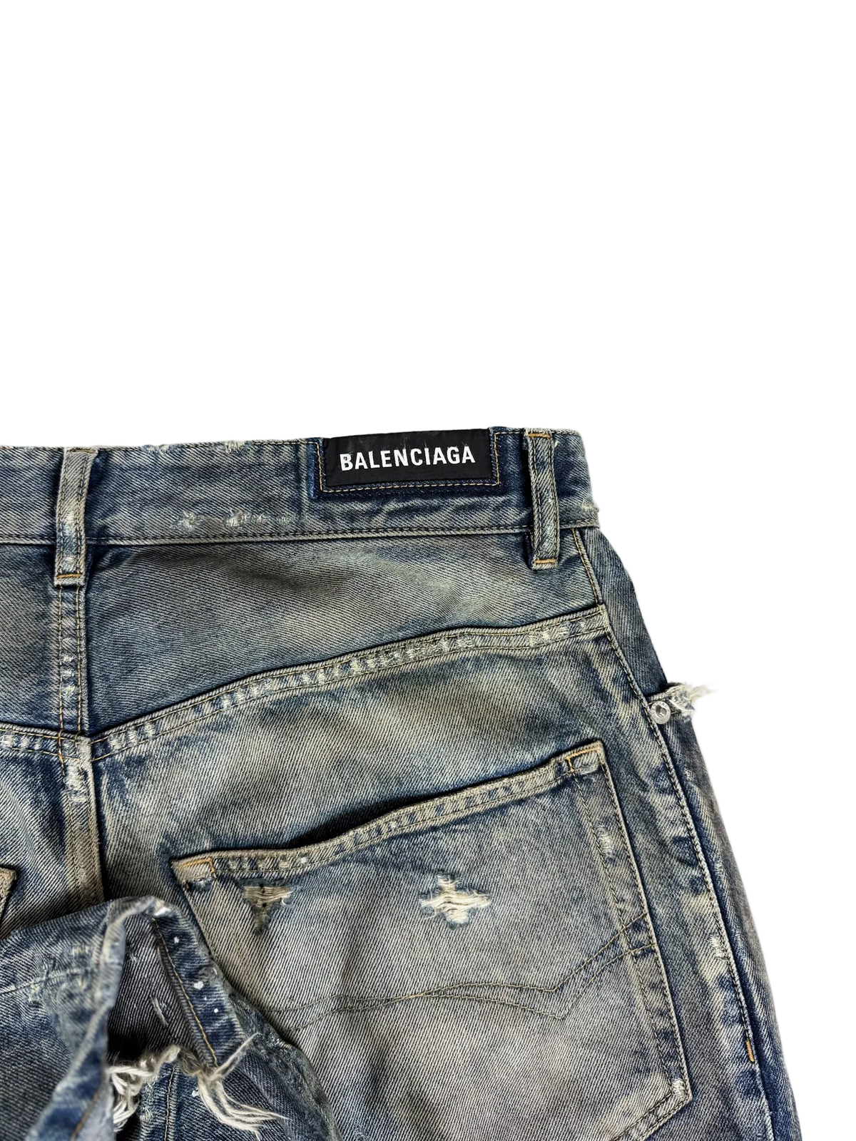 Blue denim jeans close-up with BALENCIAGA waistband label and stitched pocket