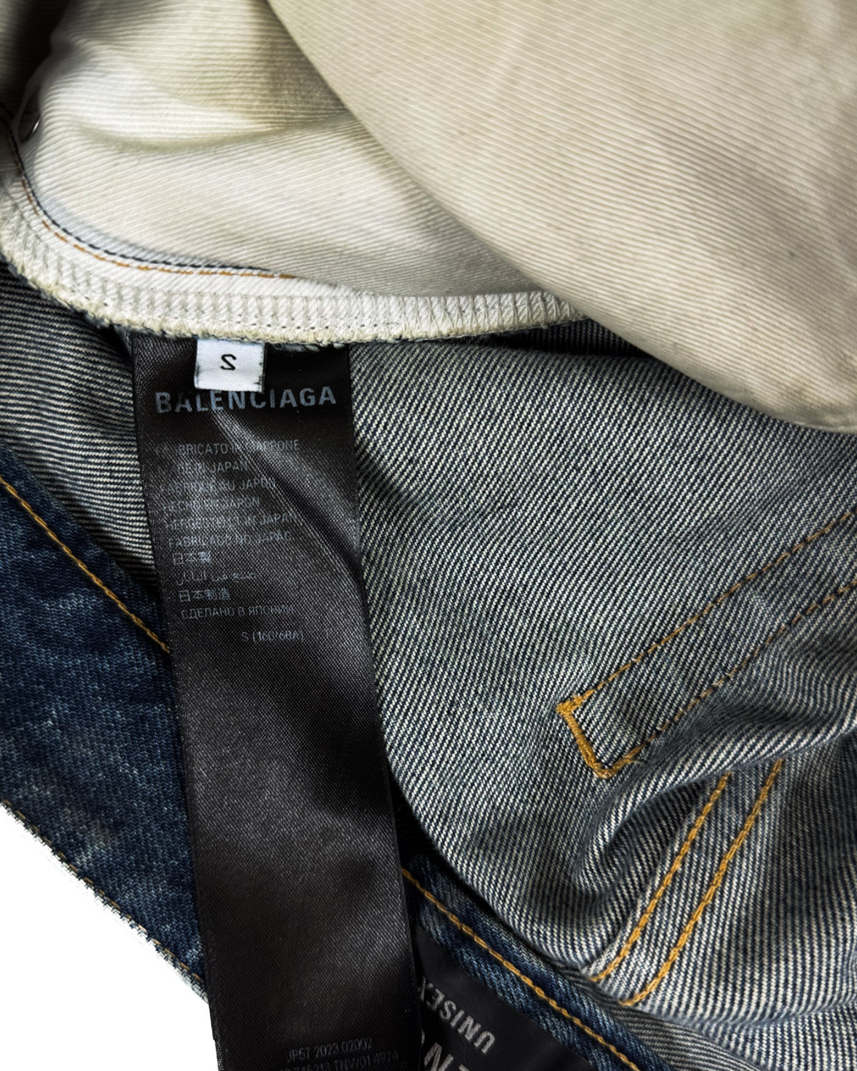Blue denim jeans with BALENCIAGA care label and brand tag near side seam