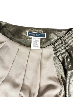 Off-shoulder neckline with gathered elastic and brand label on metallic top