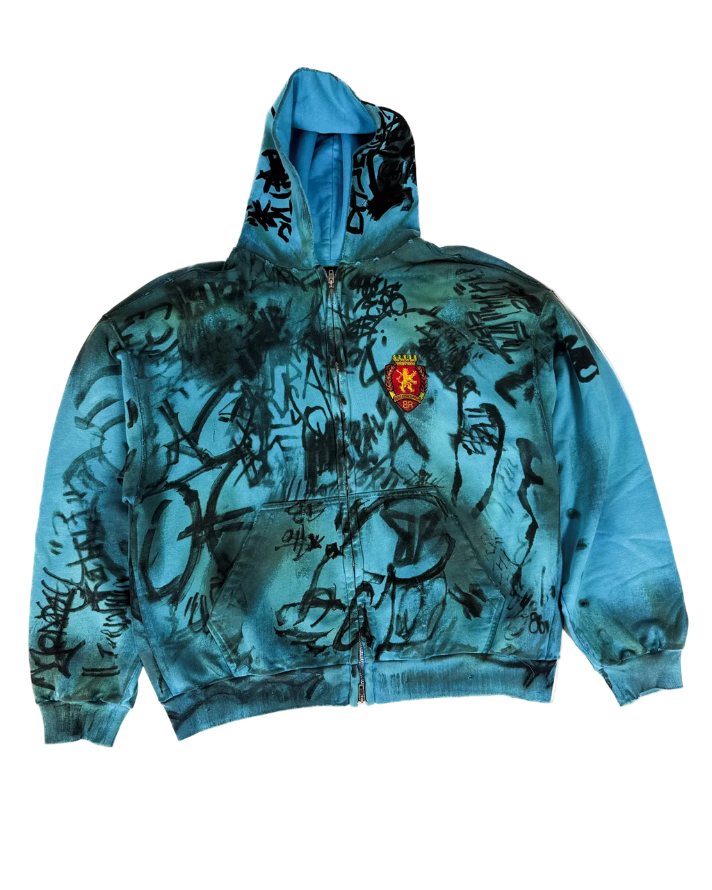Blue zip-up hoodie with graphic scribble print and crest patch, pullover hood