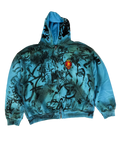 Blue zip-up hoodie with graphic scribble print and crest patch, pullover hood