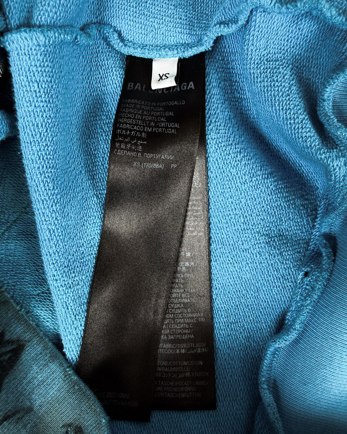 Balenciaga size XS fabric label on blue zip-up hoodie interior
