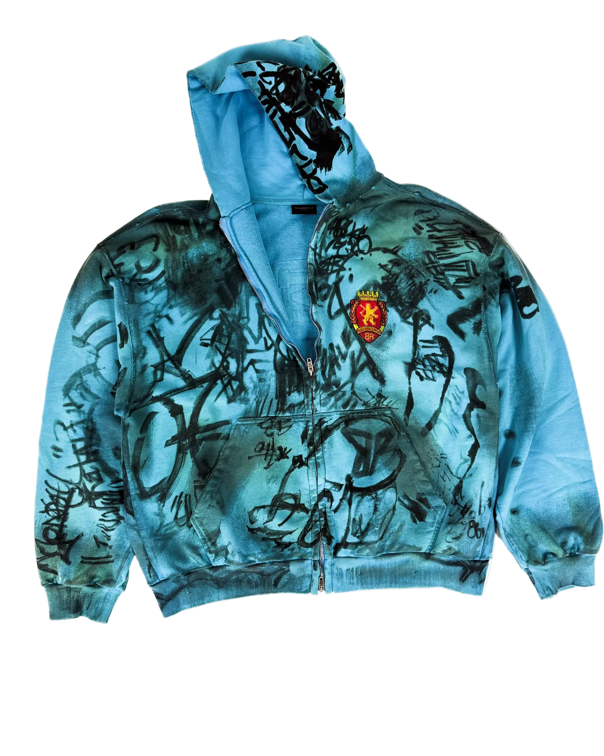 Blue zip-up hoodie with scribble graphic print, front zipper, and crest patch
