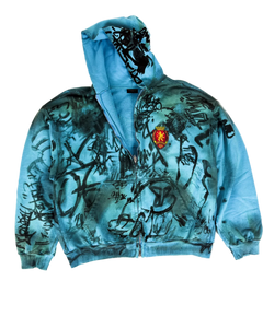 Blue zip-up hoodie with scribble graphic print, front zipper, and crest patch
