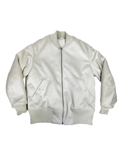 Ivory bomber jacket with front zipper, ribbed cuffs, and two flap pockets