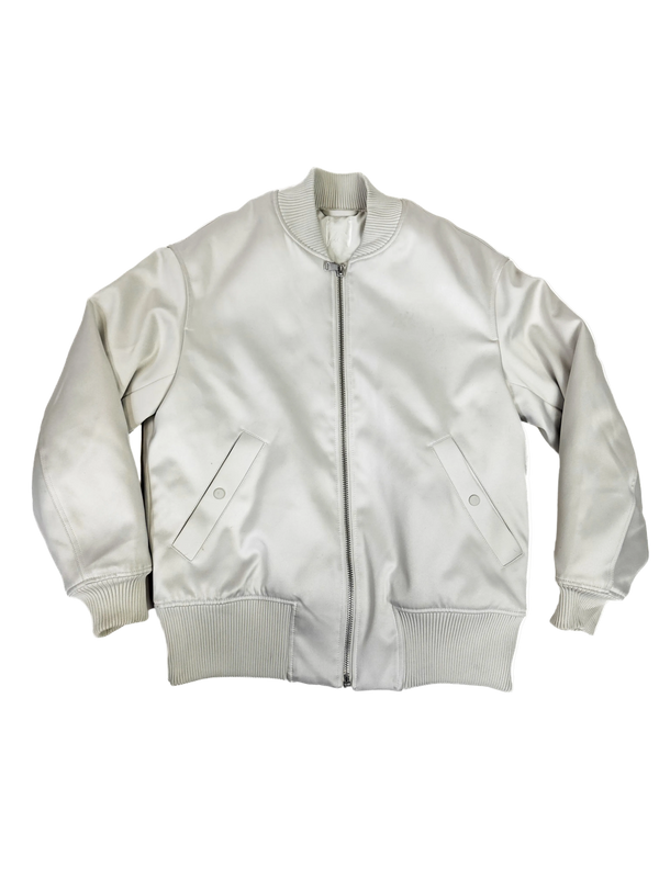 Ivory bomber jacket with front zipper, ribbed cuffs, and two flap pockets