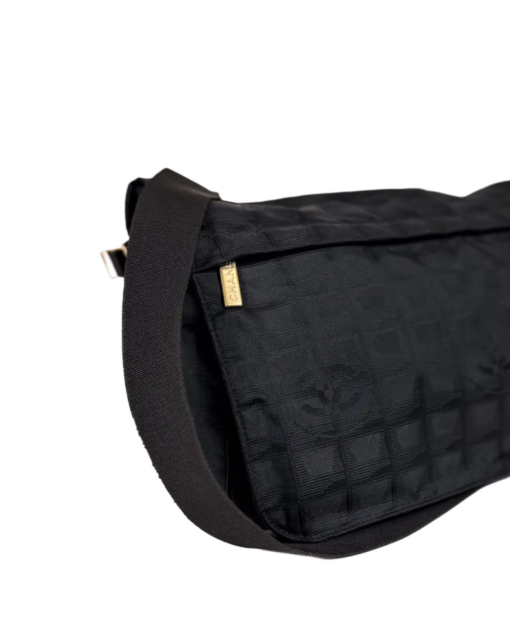 Chanel dark nylon messenger bag with textured shoulder strap and gold logo tab