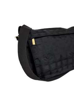 Chanel dark nylon messenger bag with textured shoulder strap and gold logo tab