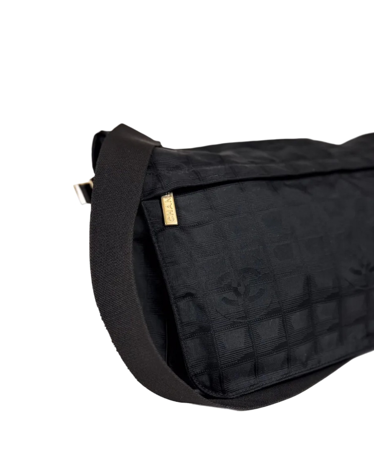 Chanel dark nylon messenger bag with textured shoulder strap and gold logo tab