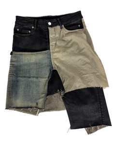 Layered patchwork denim skirt in black, beige, and light blue with frayed raw hem