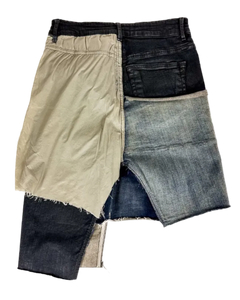 Patchwork denim skirt with beige and dark blue panels, raw edges, front button closure