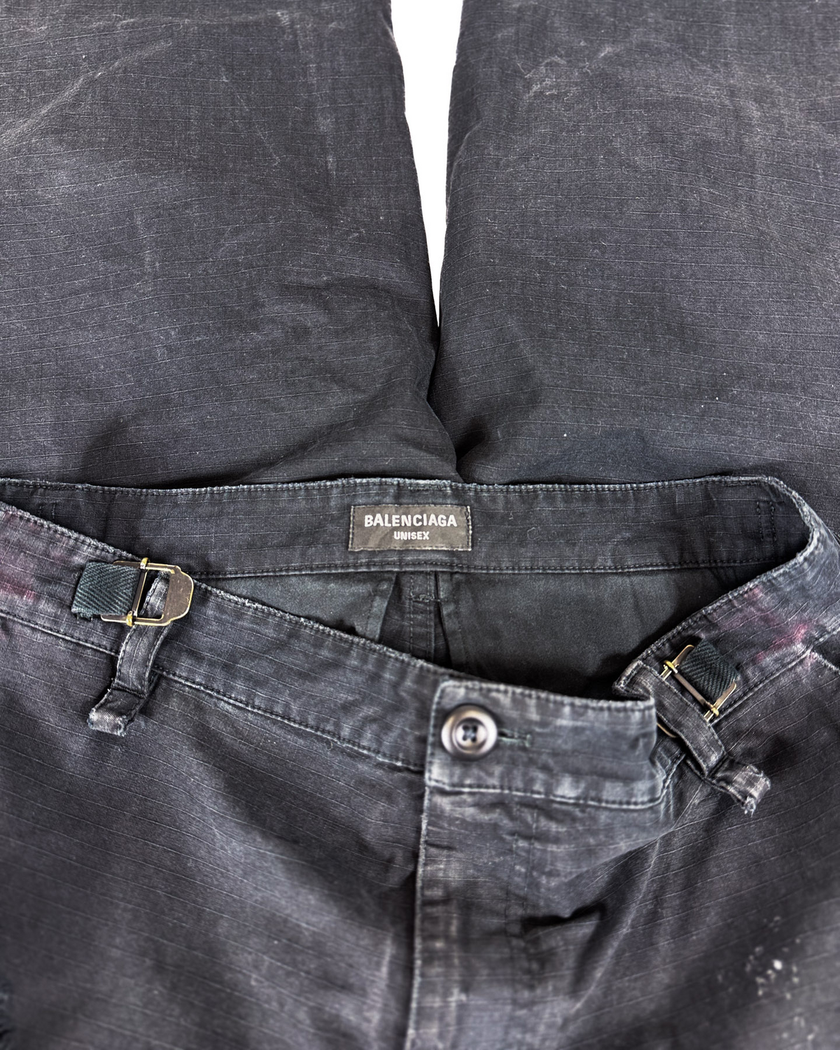Distressed cargo pants, dark gray waistband with buckle loops and button front