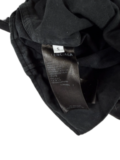Distressed cargo pants, dark gray interior label near waistband