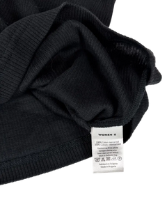 Dark singlet fabric close-up with internal label and care tag