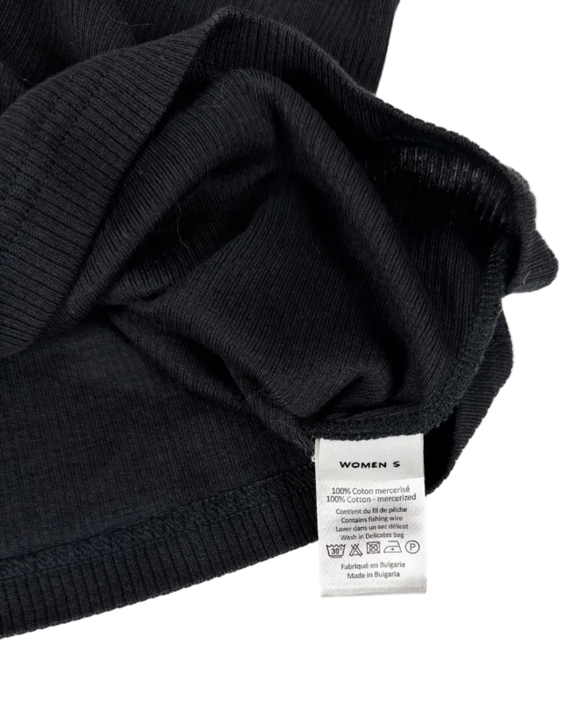 Dark singlet fabric close-up with internal label and care tag
