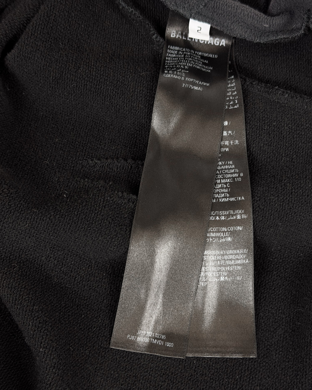 Balenciaga hoodie fabric close-up with size label tag near neckline