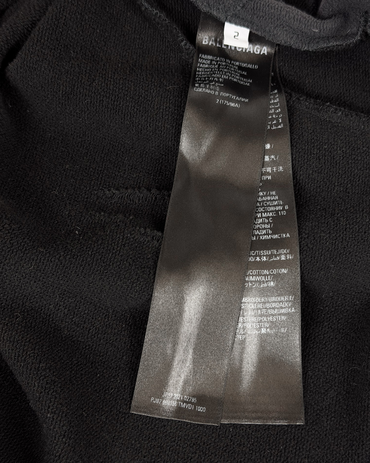 Balenciaga hoodie fabric close-up with size label tag near neckline